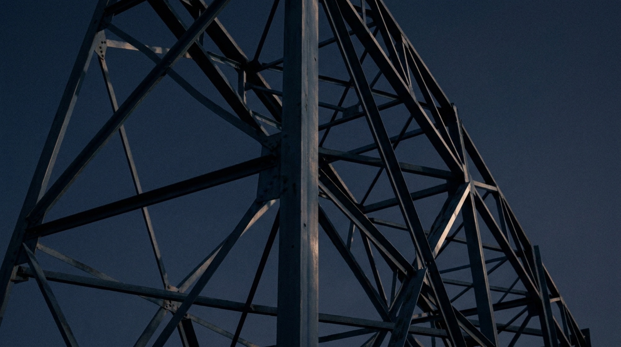 Steel lattice structure against a dusk sky